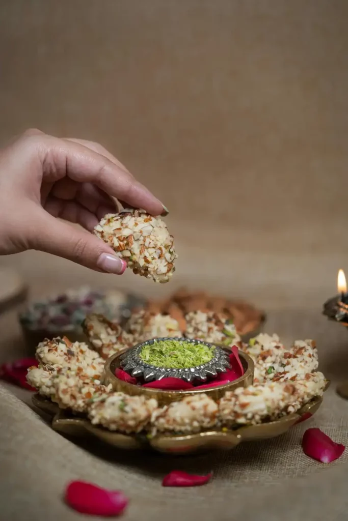 A close up of a hand picking a Coconut Mawa Firecracker from the plate