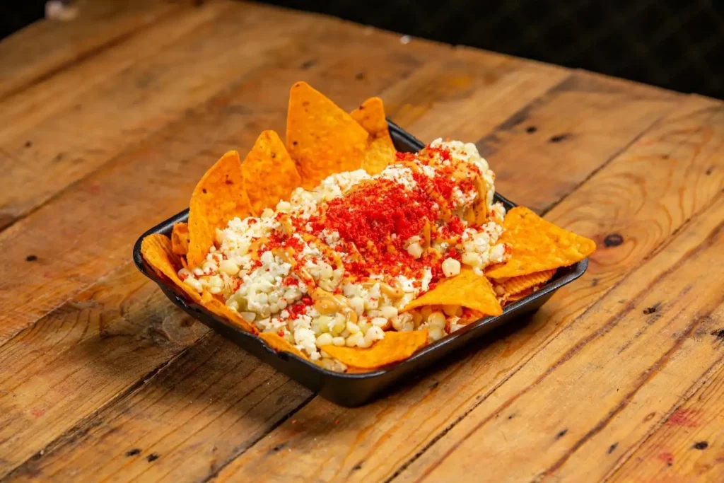 A plate of nachos with cashew chipotle dressing and cheese.