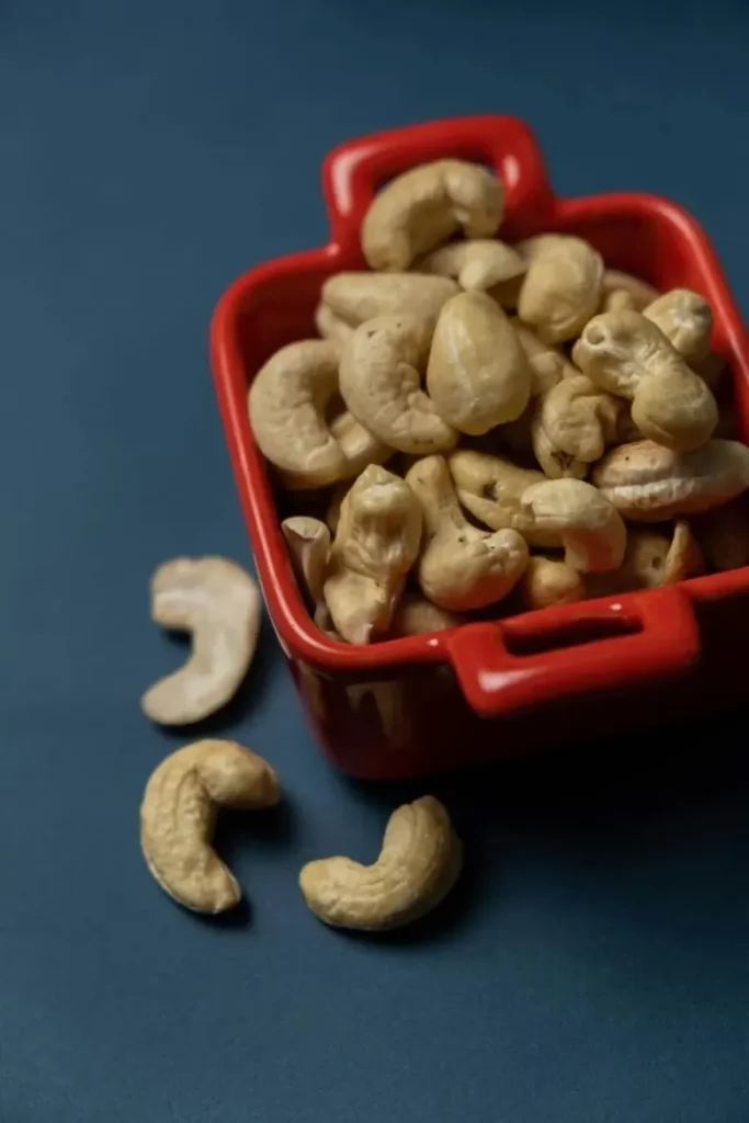 A close up of Goan cashew nuts in a red container.