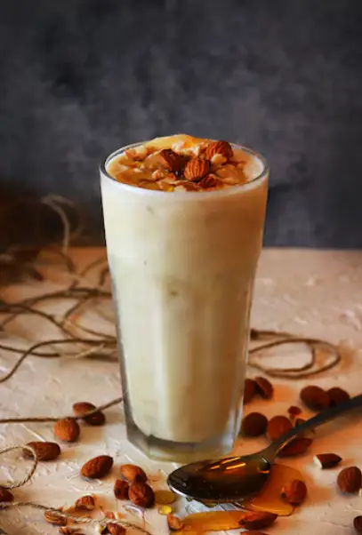 A glass full of nutty milkshake made with Zantye's cashews, almonds, and pistachios