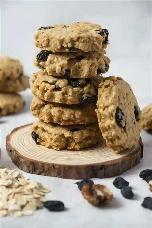 Neatly stacked oatmeal cookies made with Zantyes cashew butter and raisins