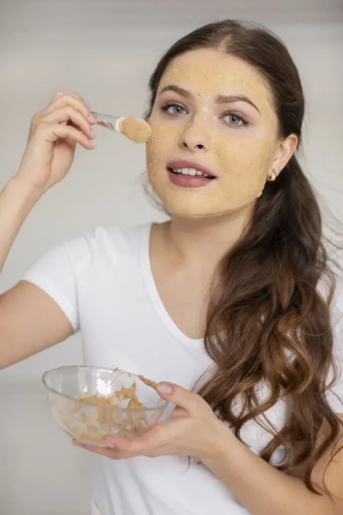 Woman applying DIY mask made from Cashew nuts.